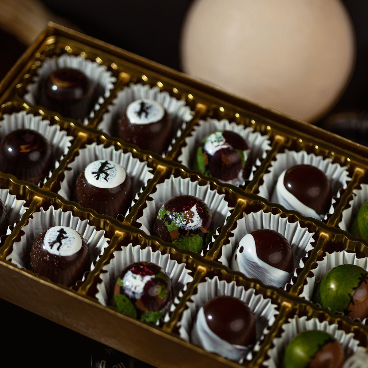 Assorted chocolates in a decorative box with blurred background